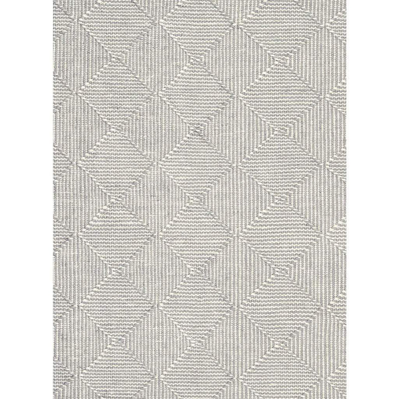 Zala Slate Rug is a recycled rug handwoven from 100% repurposed plastic bottles.  This recycled flat weave rug features a diamond weave pattern in pale grey and neutral yarns. Close up of weave shown.