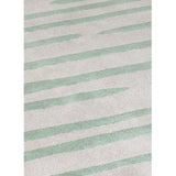 Island Leaf Rug is an abstract lines patterned rug in two colours, cream and green. The abstract lines pattern creates a circle design within this rectangular wool rug. Rug pile close up.