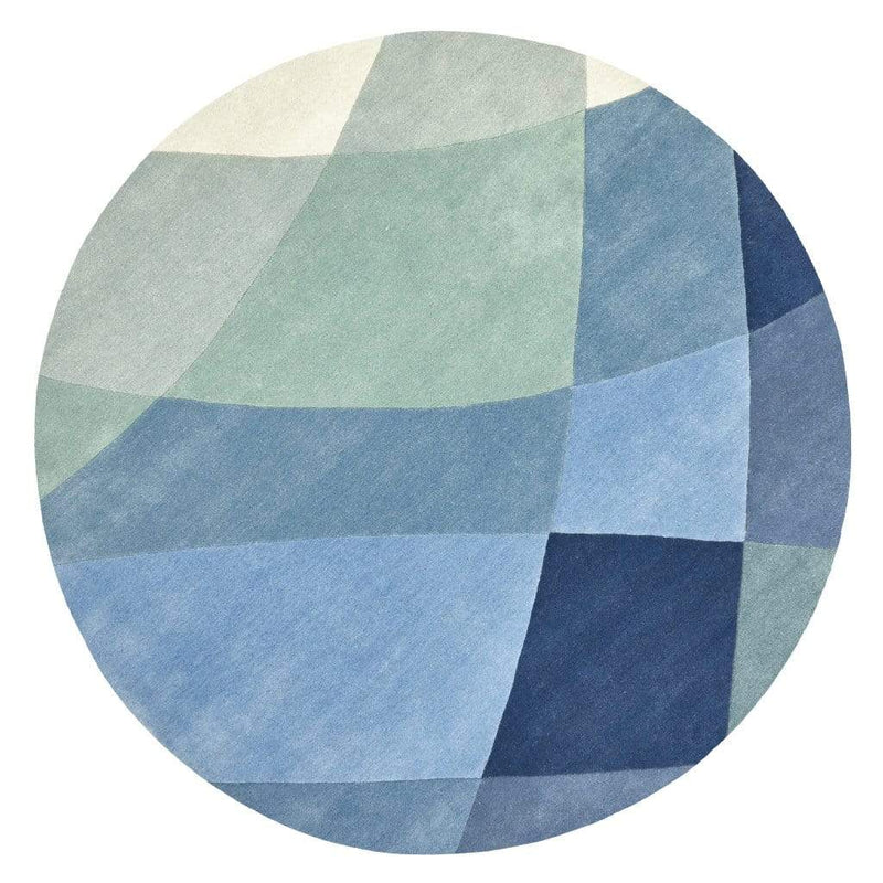 Rhythmic Tides Indigo Round Rug is an ocean themed round rug. It is designed in stunning blue-greens with a curved pattern to depict the ebb and flow of the tides. This is a contemporary coastal inspired rug, perfect for indoor living rooms, bedrooms or dining rooms.