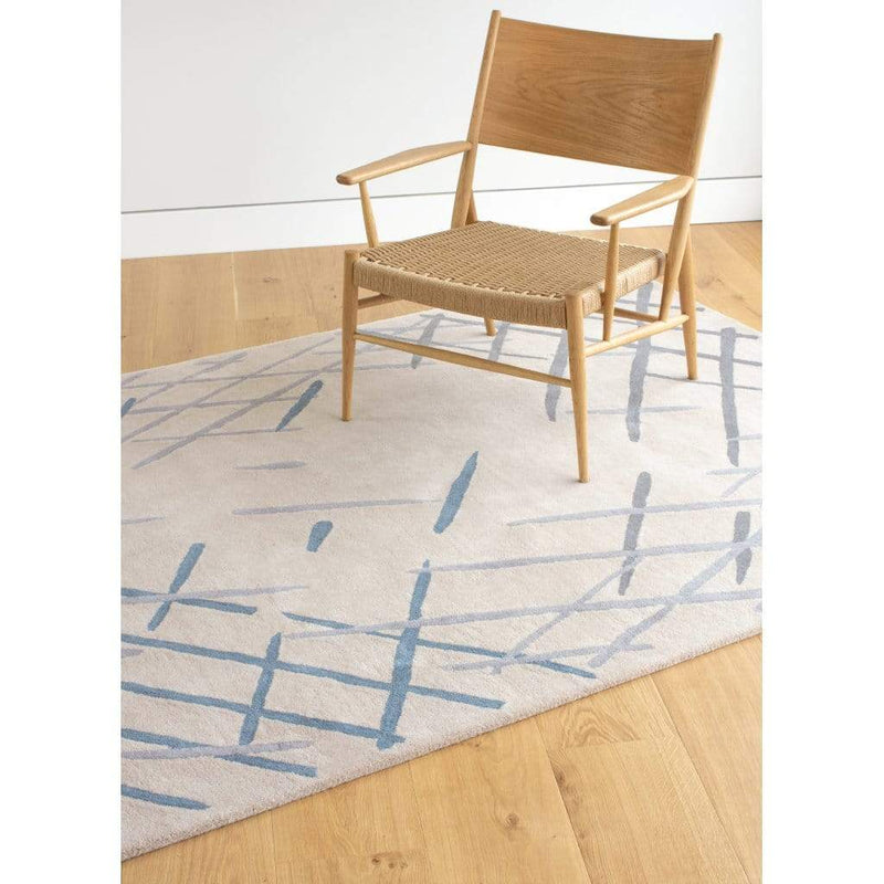 Sand Sketch Rug is a beautiful cream wool rug with a nature inspired, painterly pattern. Soft blue, grey and charcoal colours decorate the warm cream wool background. 