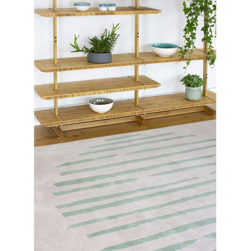 Island Leaf Rug is an abstract lines patterned rug in two colours, cream and green. The abstract lines pattern creates a circle design within this rectangular wool rug.
